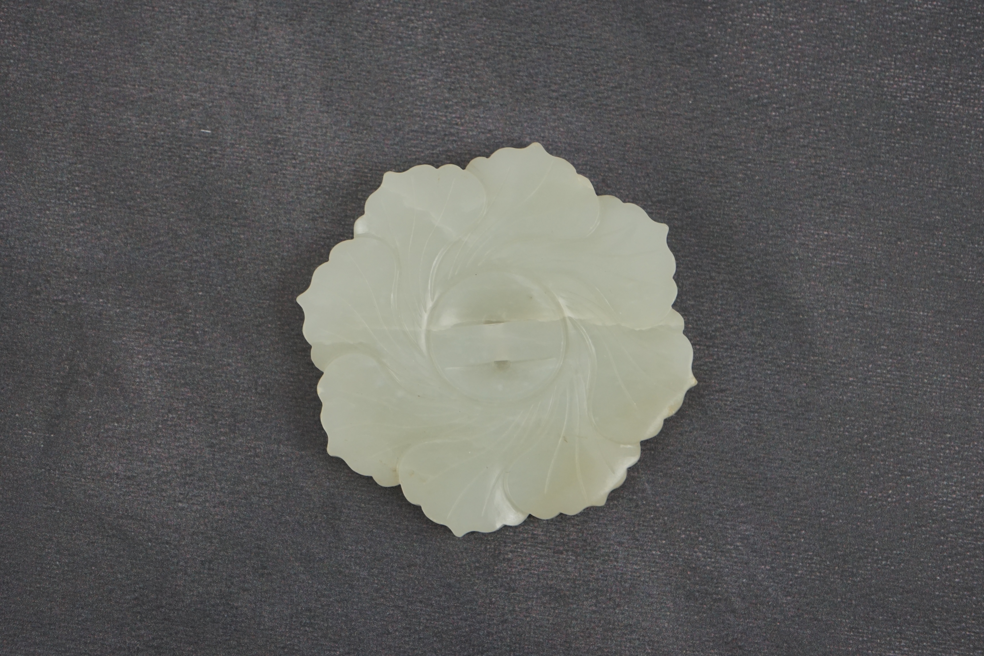 A Chinese pale celadon jade ‘mallow flower’ plaque, 18th/19th century